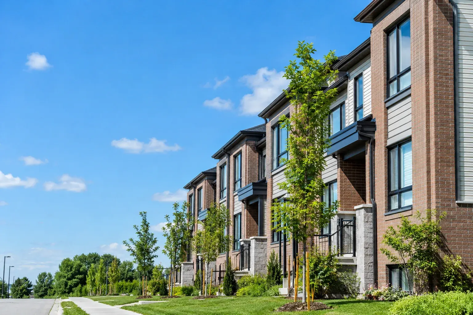 New townhomes in a suburban Ottawa community on a bright morning, typical starter homes for a first time home buyer Ottawa